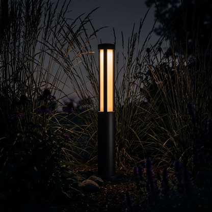 Lumira bollard light lighting a dark garden at night