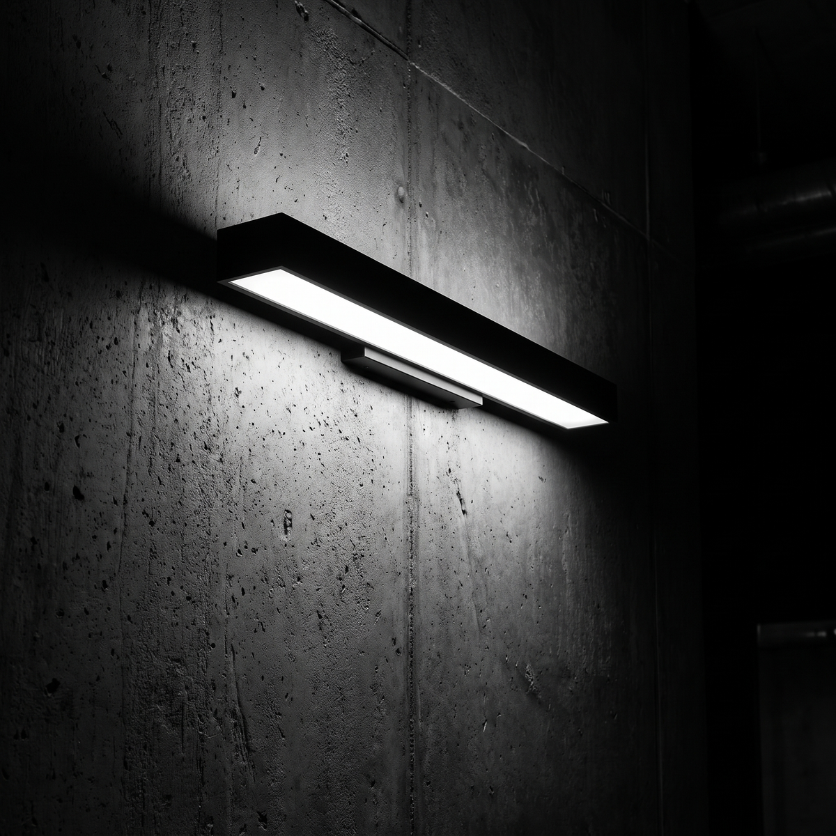 Verano wall light grazing a dark concrete wall at night