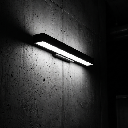 Verano wall light grazing a dark concrete wall at night