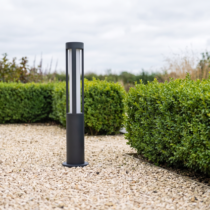 Lumira bollard light in gravel beside clipped hedging in daylight